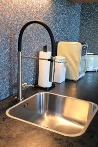 a kitchen sink with a faucet on a counter at Ferienwohnung Parterre in Varel