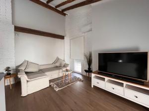a living room with a large flat screen tv at 18 Torres Estébanes in Zaragoza