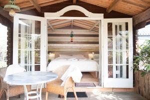 a bedroom with a bed and a table on a patio at Bamboo Lodge Groningen in Groningen