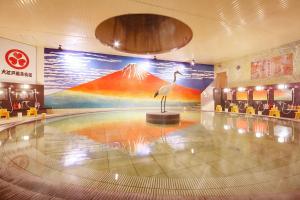 a lobby with a statue of a bird in a building at Ooedo Onsen Monogatari Minoh Kanko Hotel in Minoo