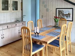 a dining room with a wooden table and chairs at 6 person holiday home in Ansager in Ansager