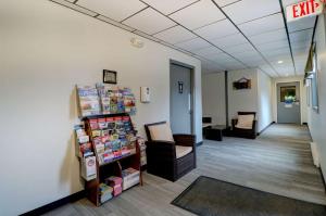 an office lobby with a waiting room with chairs and a sign at Quality Inn & Suites in Lincoln