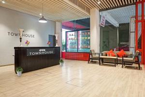 a view of the front of a town house with a table and chairs at Townhouse Somani TC in Pune