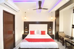um quarto com uma cama grande e almofadas vermelhas em OYO Hotel Ska Hometel em Chandīgarh