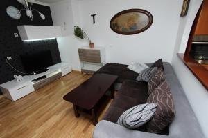 a living room with a couch and a table at Apartment Ilinović in Rovinj