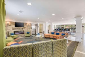 a large living room with couches and a fireplace at MainStay Suites Columbus next to Fort Moore in Columbus