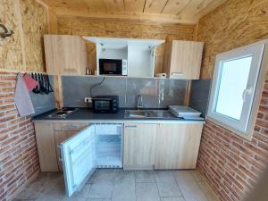 a small kitchen with a sink and a microwave at Mike's Rooms in Kobarid