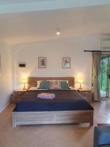 a bedroom with a large bed and two lamps at Clandulla Cottages & Farmstay in Boyland
