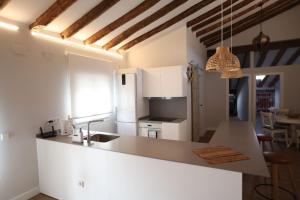 a kitchen with white cabinets and a counter top at 18 Torres Estébanes in Zaragoza