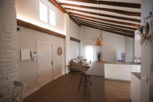 a kitchen and living room with white walls at 18 Torres Estébanes in Zaragoza