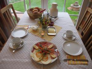 a table with a plate of food on it at Weinhof Michael Morbach in Zeltingen-Rachtig