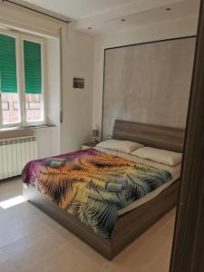 - une chambre avec un lit et une couette colorée dans l'établissement La casa del Lubra, à Piombino
