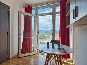 a room with a table and a large window at JG Studio apartment in Vranjina