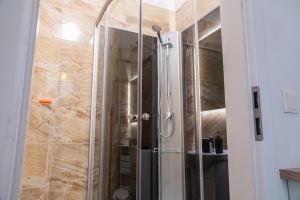 a shower with a glass door in a bathroom at Family&Friends Apartments Schönbrunn in Vienna