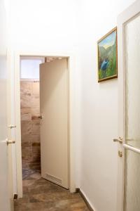 a bathroom with a white door and a shower at Family&Friends Apartments Schönbrunn in Vienna