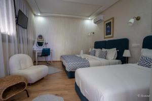 Voodi või voodid majutusasutuse Hôtel ZIRYAB toas