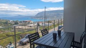 a table with chairs and a view of the ocean at Marigold Apartments in Chania Town
