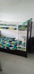 a bedroom with a bunk bed with a colorful comforter at Blue Largo Sea View in Westbrook