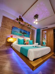 sypialnia z dużym łóżkiem z niebieskim oświetleniem w obiekcie Wonder Nerja Paraiso Apartamento w mieście Nerja
