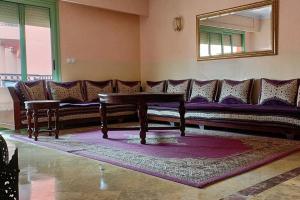 a living room with a couch and a table at Apartamento en Majorelle, Marrakech. in Marrakesh