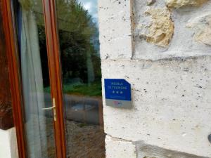 a sign on the side of a building next to a door at Domaine Jasmin, 6 Gîtes typiquement Charentais avec Piscines in Bellon