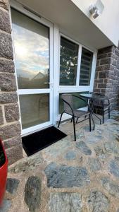 a patio with a table and chairs next to a window at Appart 2 chambres avec extérieur in Cherbourg en Cotentin