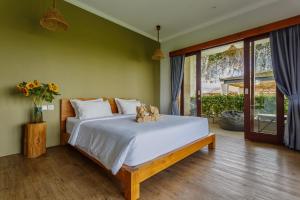 a bedroom with a bed with a teddy bear on it at Canggu Hype in Canggu