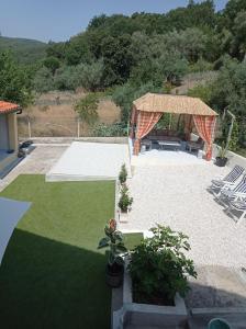 a backyard with a gazebo and a lawn at La maison du bonheur in Celavisa +17 photos