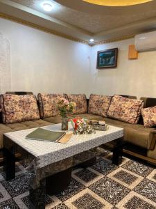 a living room with a couch and a table at Caravan Castle Boutique Hotel in Bukhara