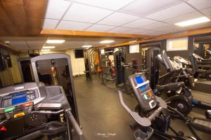 a gym with tread machines and a cell phone at Apartamenty A&M in Stargard