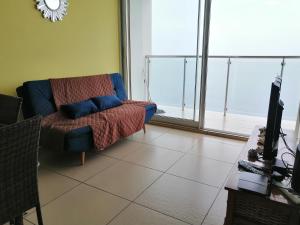 a living room with a couch and a large window at PH El Palmar Residences 2203 in San Carlos