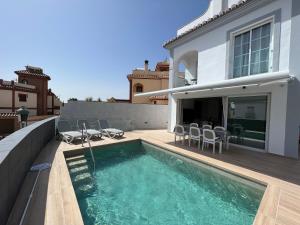 a house with a swimming pool on a balcony at Villa Antonia Mar - Private Pool - Punta Lara Nerja in Nerja