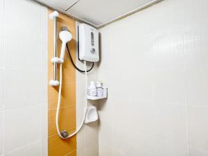 a shower in a bathroom with a toilet at Simply Cosy Homestay in Batu Caves