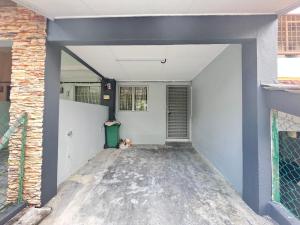 an empty garage with a door in a building at Simply Cosy Homestay in Batu Caves