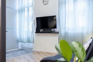 a living room with a flat screen tv on a wall at Venus Apartments - City Park II in Budapest
