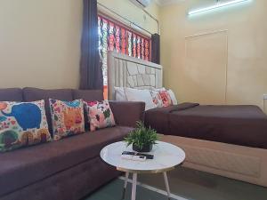 a living room with a couch and a table at OSI Apartments Khar West in Mumbai