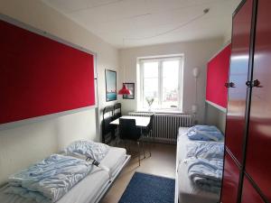 Postel nebo postele na pokoji v ubytování Femmasteren Hotel & Hostel