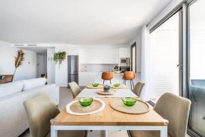 a dining room and living room with a table and chairs at Apartamento Dora Maar I in Marbella