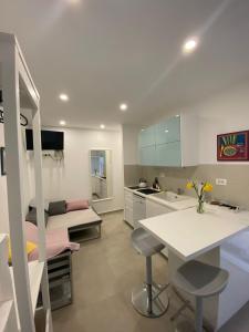 a kitchen with a table and chairs in a room at Lovely Suite in Šibenik