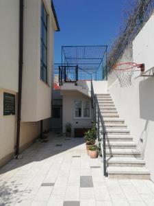 an empty courtyard with stairs and a basketball hoop at Lovely Suite in Šibenik