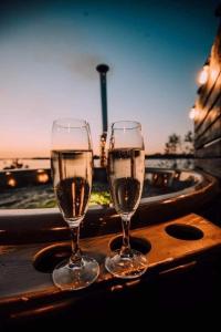 two glasses of wine sitting on a table at Doles skati in Salaspils