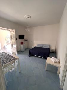 a bedroom with a bed and a table in it at Maison emi in Montecorice