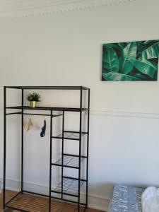 a black shelf with a plant on top of it at Rainbow Guest House in Lisbon
