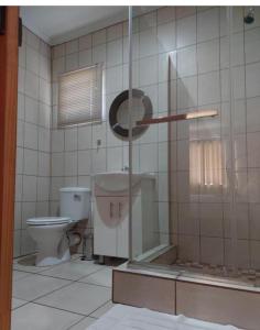 a bathroom with a toilet and a glass shower at Pro Plants Accommodation in Kimberley