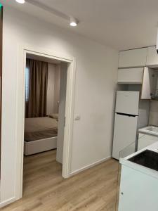 une cuisine avec une porte menant à une chambre dans l'établissement Beach apartment, à Durrës
