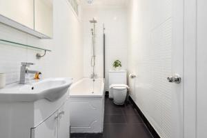 a white bathroom with a sink and a toilet at Do not use in London