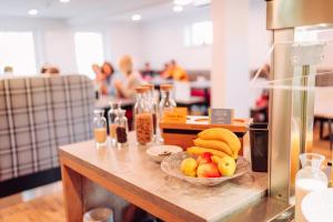 a table with a bowl of fruit on it at K1 Hotel Willingen in Willingen