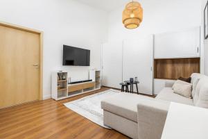 a living room with a couch and a flat screen tv at Venus Apartments - Opera II in Budapest