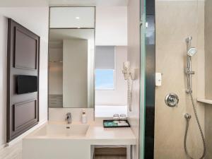 a bathroom with a sink and a shower at Ibis Styles Phuket City in Phuket Town