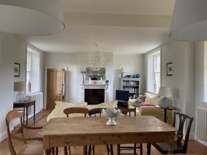 a living room with a table and a fireplace at Station House, Gilling in Gilling East